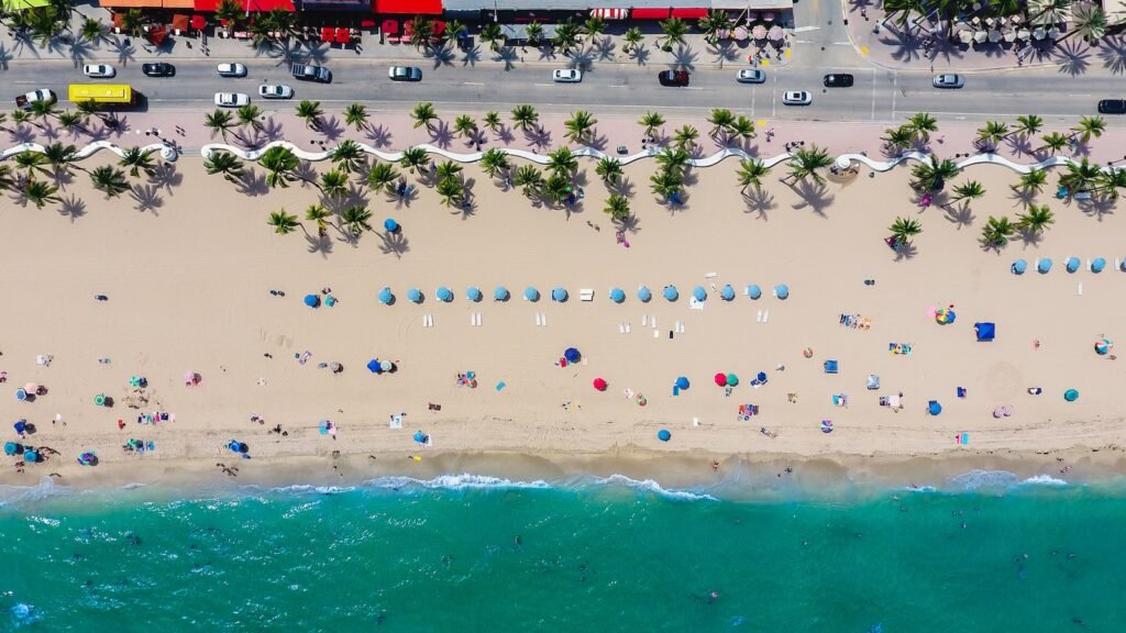 Now Air Conditioning HVAC Services in Wellington, FL and Surrounding areas. An aerial photo of a beach with people and umbrellas.