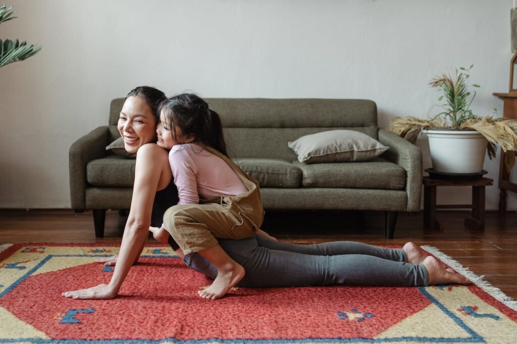 Now Air Conditioning | Heating Maintenance in Wellington, West Palm Beach, Boca Raton and the surrounding area. Photo of Girl Hugging Her Mom While Doing Yoga Pose