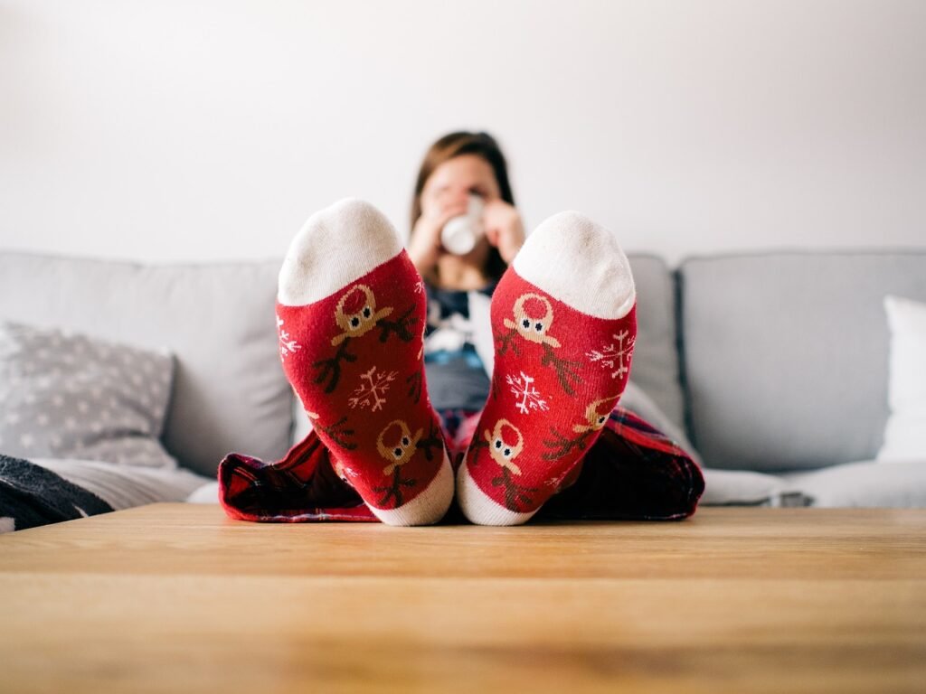 Now Air Conditioning | Heating Services in Wellington, West Palm Beach, Boca Raton and the surrounding area. A photo of a woman sipping tea and wearing cozy socks.