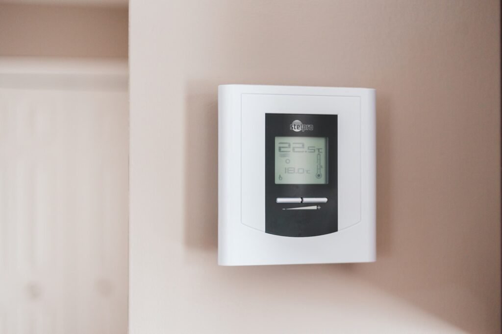 Now Air Conditioning | Heating Services in Wellington, West Palm Beach, Boca Raton and the surrounding area. A photo of white and gray thermostat.