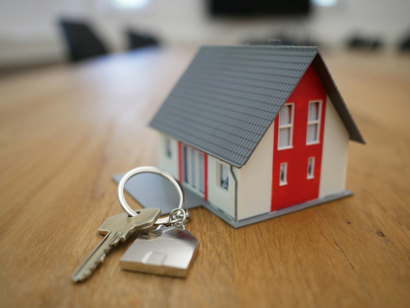 First-Time Homeowners' Guide to HVAC Maintenance | A photo of a small red and white house next to a keychain.